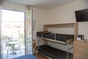 Postel nebo postele na pokoji v ubytování Hotel Delle Mimose