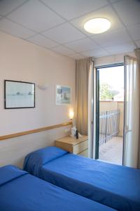 Postel nebo postele na pokoji v ubytování Hotel Delle Mimose
