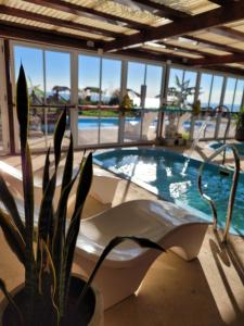 a bath tub sitting next to a swimming pool at Punta Encanto Posada Boutique in Miramar +20 photos