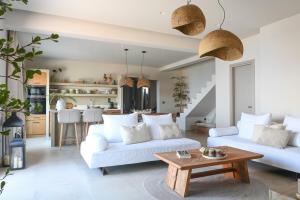 a living room with two white couches and a table at Villa Ino in Myrties