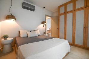 a bedroom with a large white bed and a window at Villa Ino in Myrties +34 photos