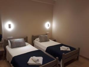 a room with two beds with towels on them at Value Double Lower – Room 12 in Gouvia