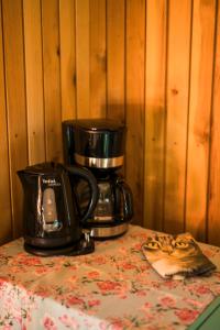 Eine Kaffeemaschine steht mit einer Kaffeekanne auf einem Tisch. in der Unterkunft Old Silent in Hara