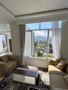 a living room with a large window at Milano Villas Puncak in Puncak