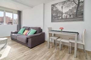 a living room with a couch and a table at Estudio Plazamar Palace in Torre del Mar