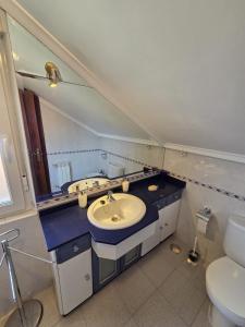 a bathroom with a sink and a mirror and a toilet at Casa el Bosque in Camargo +34 photos