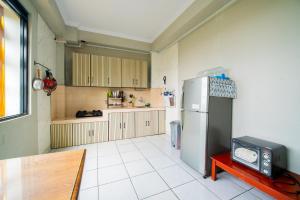 a kitchen with a refrigerator and a table in it at Behomy J-Home Bandung in Bandung