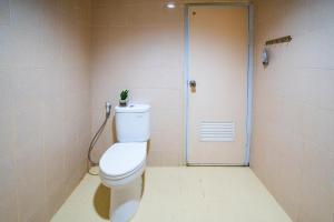 a bathroom with a toilet with a plant on top of it at Behomy J-Home Bandung in Bandung +5 photos