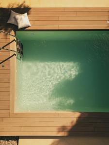 a pool of water on the side of a house at My Secret Mojo, Private Luxury Retreat Near the Beach in Lefkada