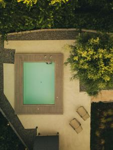 an overhead view of a swimming pool with chairs and trees at My Secret Mojo, Private Luxury Retreat Near the Beach in Lefkada