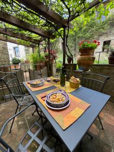 a table with plates of food on a patio at La Loggia di Montefienali in Gaiole in Chianti