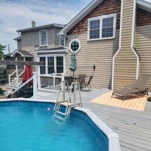 a backyard with a swimming pool and a house at Victory View in Gettysburg