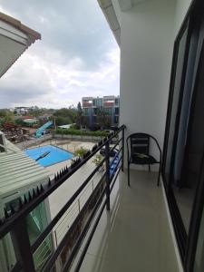 a balcony with a view of a swimming pool at Sleek Modern Studio in Rawai, Phuket in Ban Saiyuan (1)