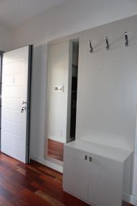 a white room with a mirror and a white dresser at Vila 26, Lura 2, Gjiri i Lalezit in Ishëm +21 photos