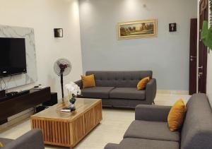 a living room with two couches and a tv at Appartement de Deux chambres Salon à Ouando - SKYFORCE Bénin in Porto-Novo