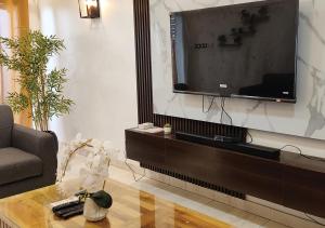 a living room with a large screen television on a wall at Appartement de Deux chambres Salon à Ouando - SKYFORCE Bénin in Porto-Novo +7 photos