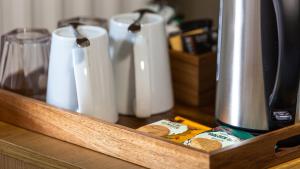 a wooden tray with a group of cups on a counter at The Granby Hotel in Whitby