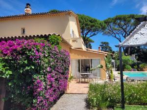 a villa with a garden and a swimming pool at Villa Esmeralda Adults Only in Les Issambres