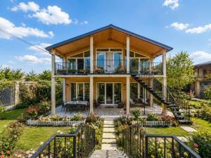 a home with a large deck and a house at Lukas cottage in sagarejo in Sagarejo