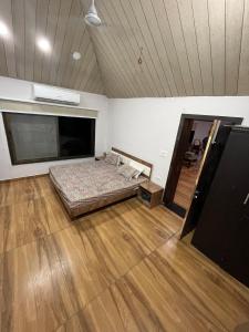 a room with a bed in the middle of a room at Kanakdhara farmhouse in Ujjain