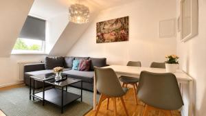 a living room with a couch and a table at URBAN FLATS Berlin in Berlin