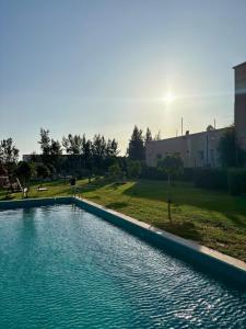 a large swimming pool with the sun in the background at Casa Biba in Utique