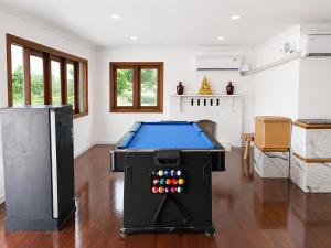 a living room with a pool table in it at Ping Dara Pool Villa Party in Ban San Pa Sak