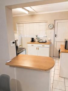 a kitchen with a wooden counter top in a room at The Olive Branch - Abbotsford in Dorchester Heights 