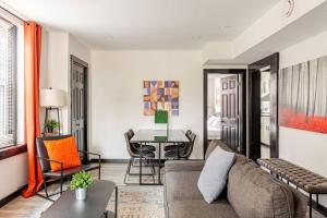 a living room with a couch and a table at Cozy 2BR,1BA Retreat for 6 with Free Parking in Philly in Philadelphia