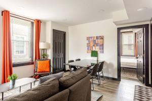 a living room with a couch and a table at Cozy 2BR,1BA Retreat for 6 with Free Parking in Philly in Philadelphia +31 photos