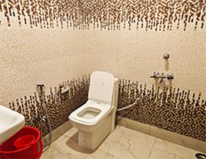 a bathroom with a toilet and a sink at Hotel Shreesh Mayapur in mayapur +44 photos