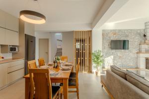 a dining room and kitchen with a table and a couch at Sofia's Villa in Riglia