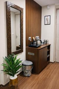 a bathroom with a sink and a mirror at Cozy Corner in Greater Noida
