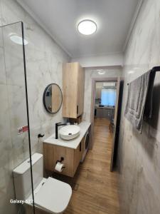 a bathroom with a sink and a mirror at Annie's cozy home in Mythimna +36 photos