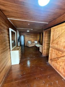 a large room with wooden walls and wooden doors at carmel cabins suite 4 in ‘Isfiyā