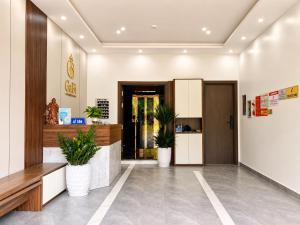 a lobby with potted plants in a building at Gabi Boutique Hotel in Mộc Châu