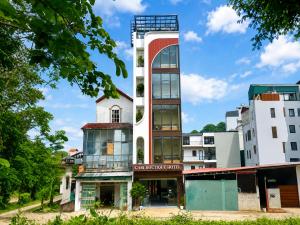 a building with a tall tower in a city at Gabi Boutique Hotel in Mộc Châu