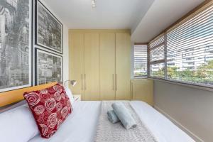 a bedroom with a bed and a large window at Comfy Central with Balcony and Views in Cape Town