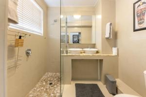 a bathroom with two sinks and a glass shower at Comfy Central with Balcony and Views in Cape Town +34 photos