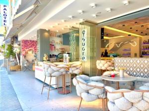 a store with chairs and tables in a mall at Palotel Gouvia Hotel in Gouvia