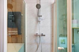 a shower with a shower head in a bathroom at Maison de vacances La Couade in Troche +22 photos