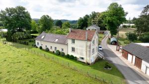 an aerial view of a large white house with a yard at Maison de vacances La Couade in Troche