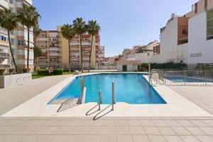 a swimming pool in the middle of a building at Estudio Plazamar Palace in Torre del Mar