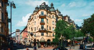 a large building on a city street with people in front of it at Hotel Kung Carl, WorldHotels Crafted in Stockholm