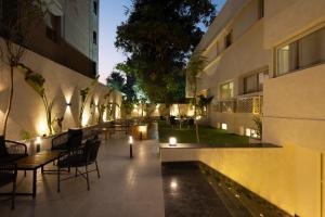 a courtyard of a building with tables and chairs and lights at Book Today & save 88 Escape by Spacey Pool-Modern-Prime spot #73- in Cairo