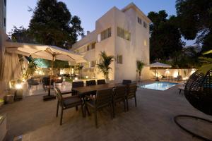 a patio with a table and chairs next to a building at Book Today & save 88 Escape by Spacey Pool-Modern-Prime spot #73- in Cairo