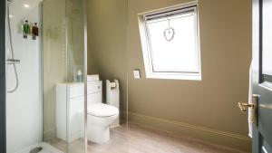 a bathroom with a toilet and a window at The Granby Hotel in Whitby