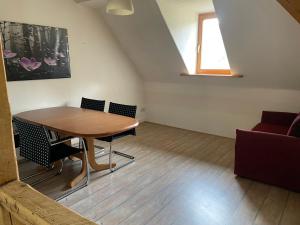 a dining room with a table and chairs and a window at Sternenblick in Neresheim