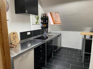a kitchen with a sink and a counter top at Sternenblick in Neresheim