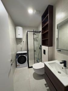 a bathroom with a shower and a toilet and a sink at Luxury 2BR Sea View & Garage & Twin Towers Becici in Bečići +37 photos